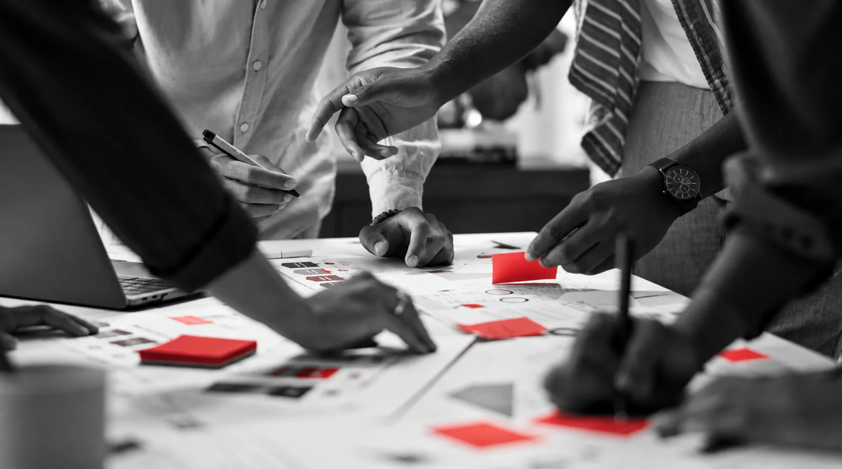 Creative team collaborating around a design table